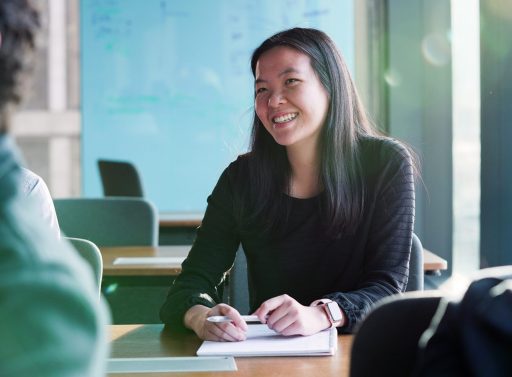 Female employee taking notes in classroom