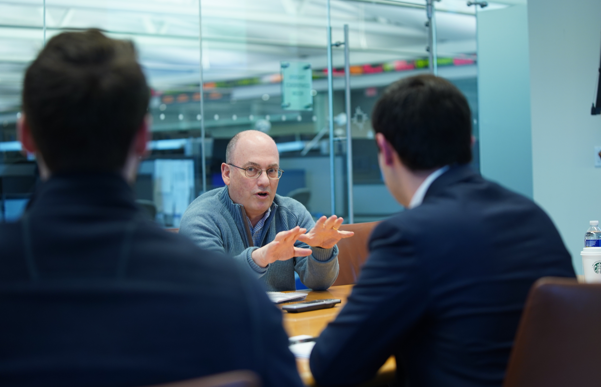 Steve Cohen speaking to two people in conference room