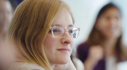 girl in glasses at meeting