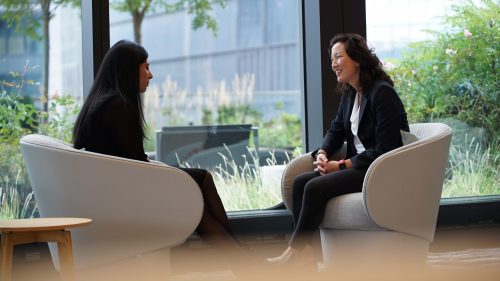 two women talking in office