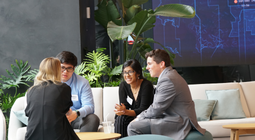 Four people chatting in Point72's Hudson Yards office