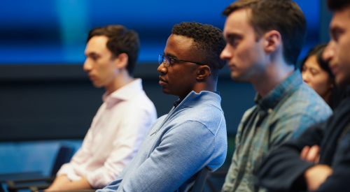 Group of people sitting and listening to a speaker off camera