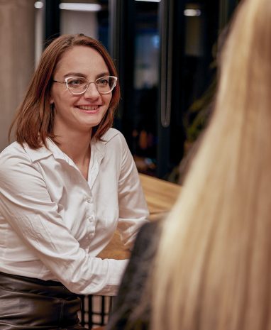 Woman in office talking to another woman