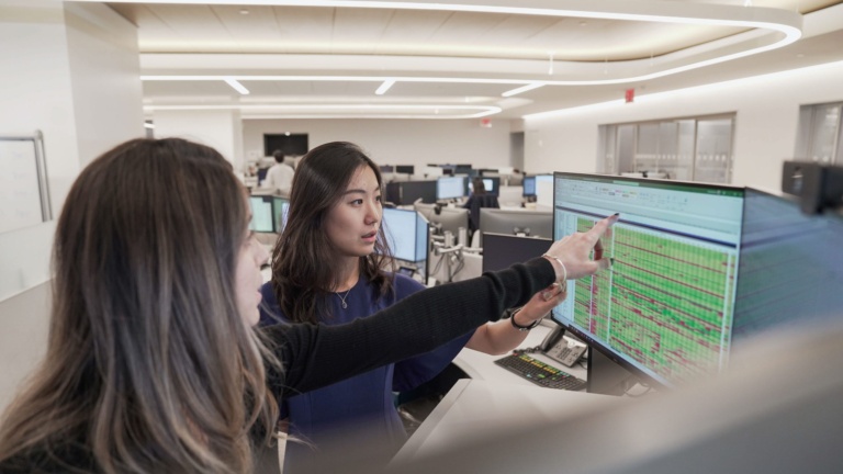 two people working at computer