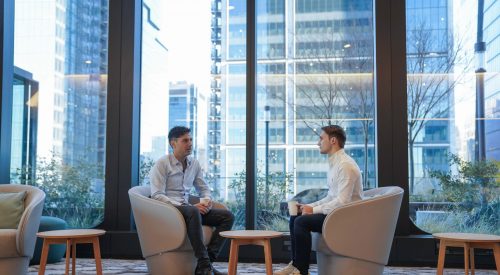 Two people sitting and talking in Point72's Hudson Yards office