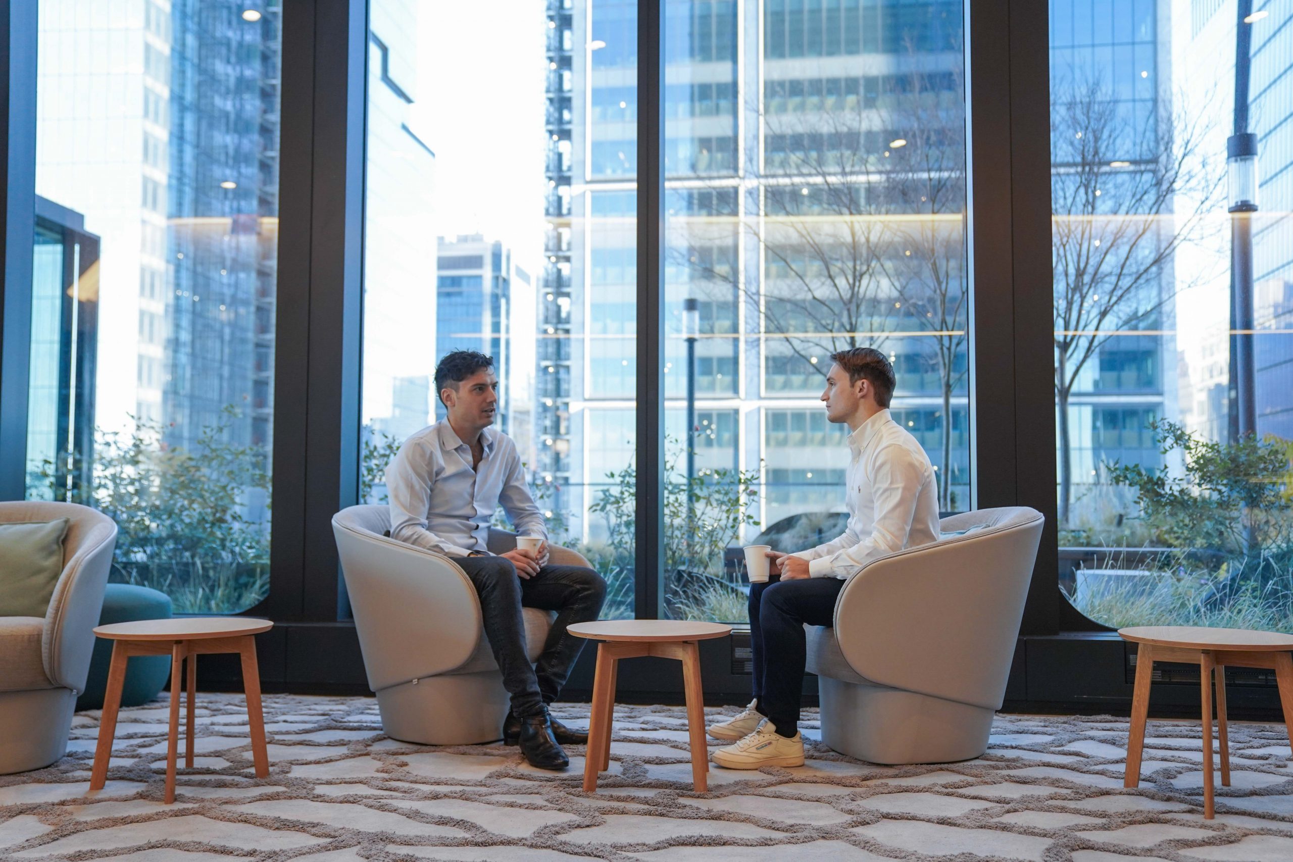 Two people sitting and talking in Point72's Hudson Yards office