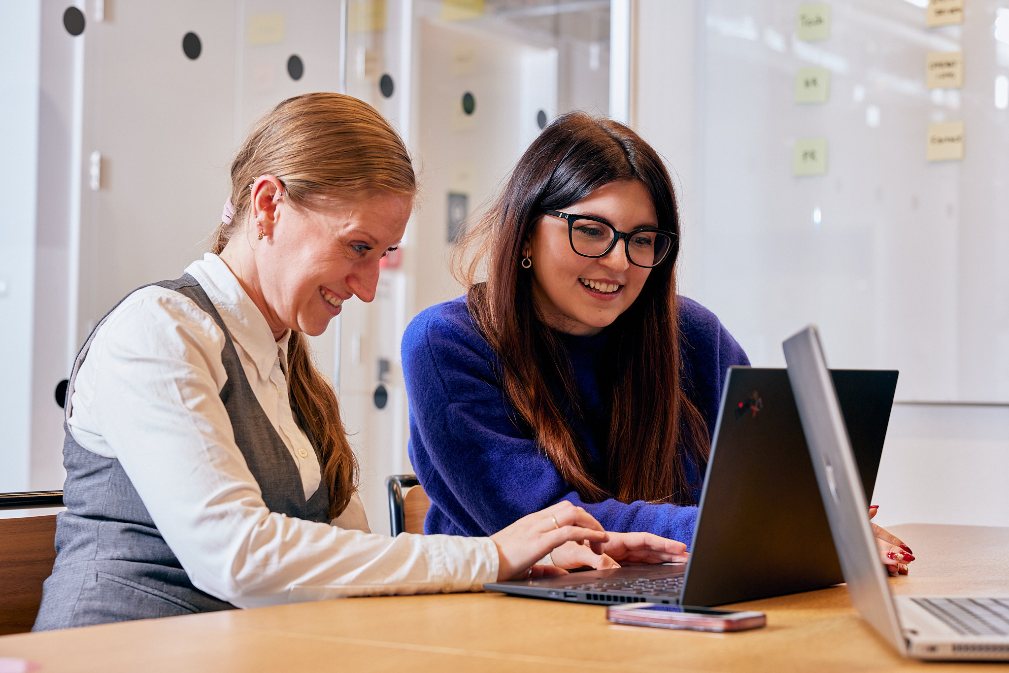 two people working together on laptop