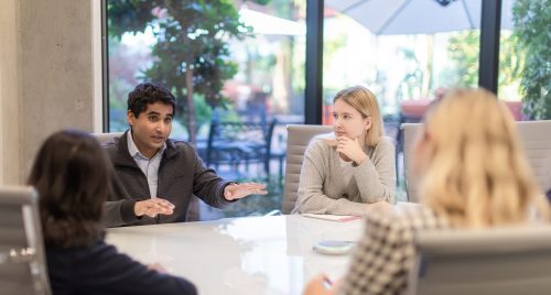 four people meeting in a conference room