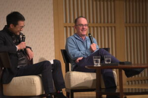 Two people talking on stage