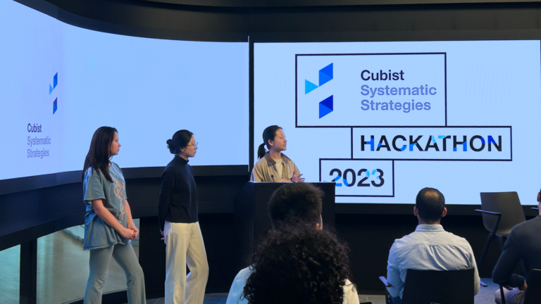 Three girls presenting at front of room