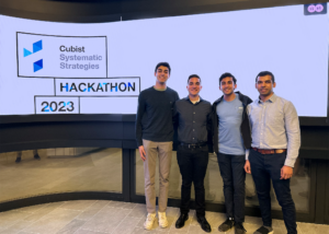 students posing in front of sign at a hackathon